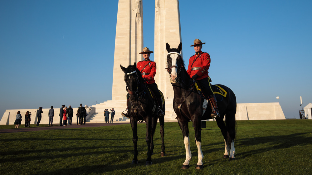 Royal Canadian Mounted Police sit on their horses in front of the Canadian National Vimy Memorial ahead of a Sunset Ceremony on April 8, 2017 in Vimy, France. 