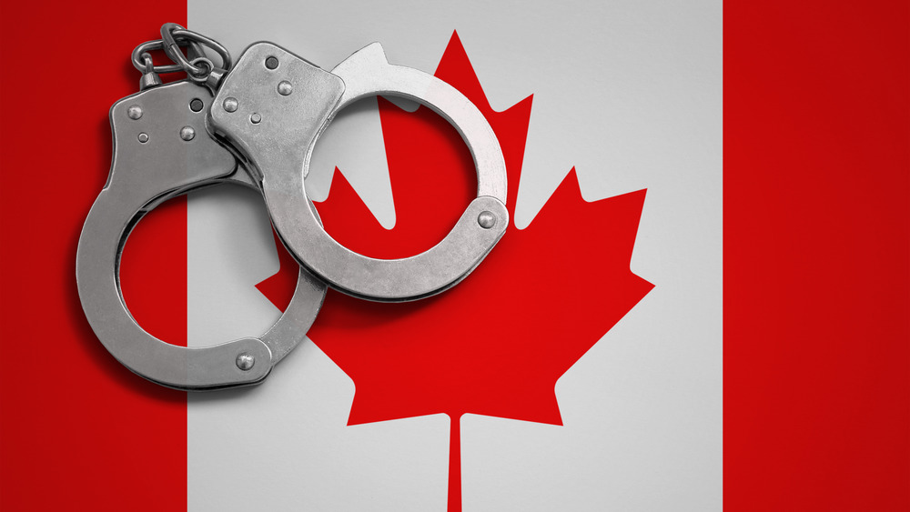 Canada flag and police handcuffs.