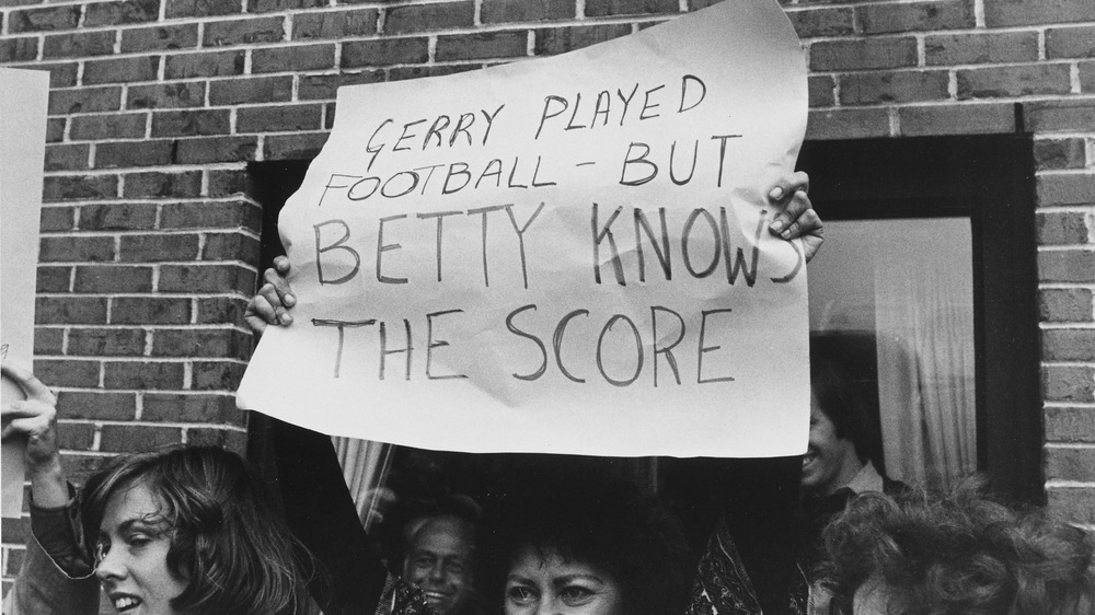 A cropped photo of a woman in 1975 holding a poster in support of Betty Ford's stance on women's rights