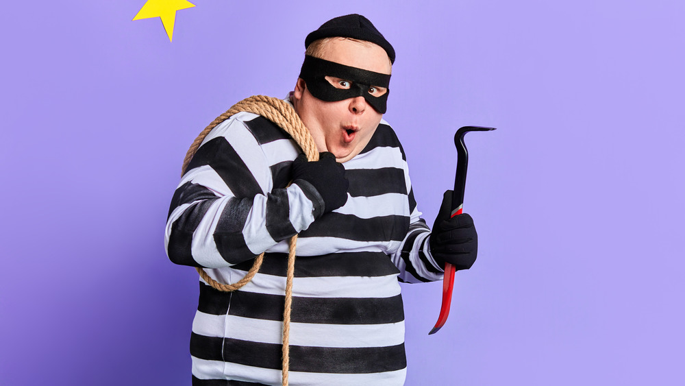 Someone dressed as a cat burglar poses for a picture