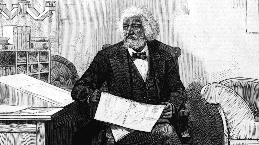 Frederick Douglass edits a journal at his desk, late 1870s