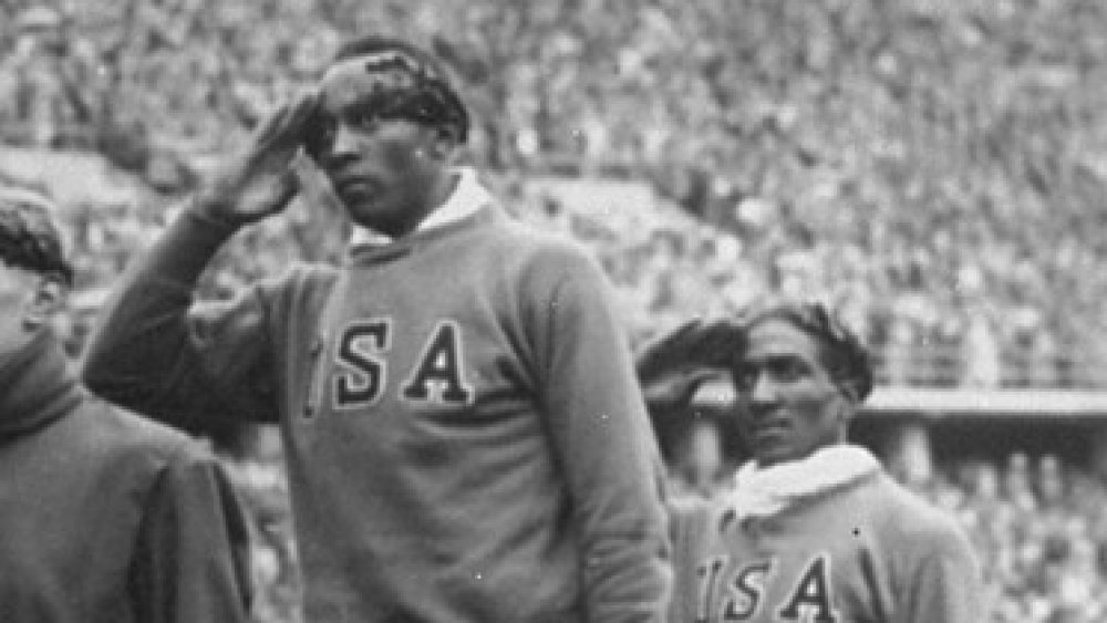 Jesse Owens and Ralph Metcalfe on the podium for the 100m medal ceremony at the 1936 Olympics