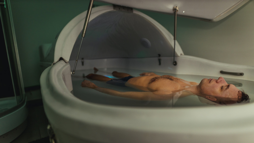 man floating in isolation tank