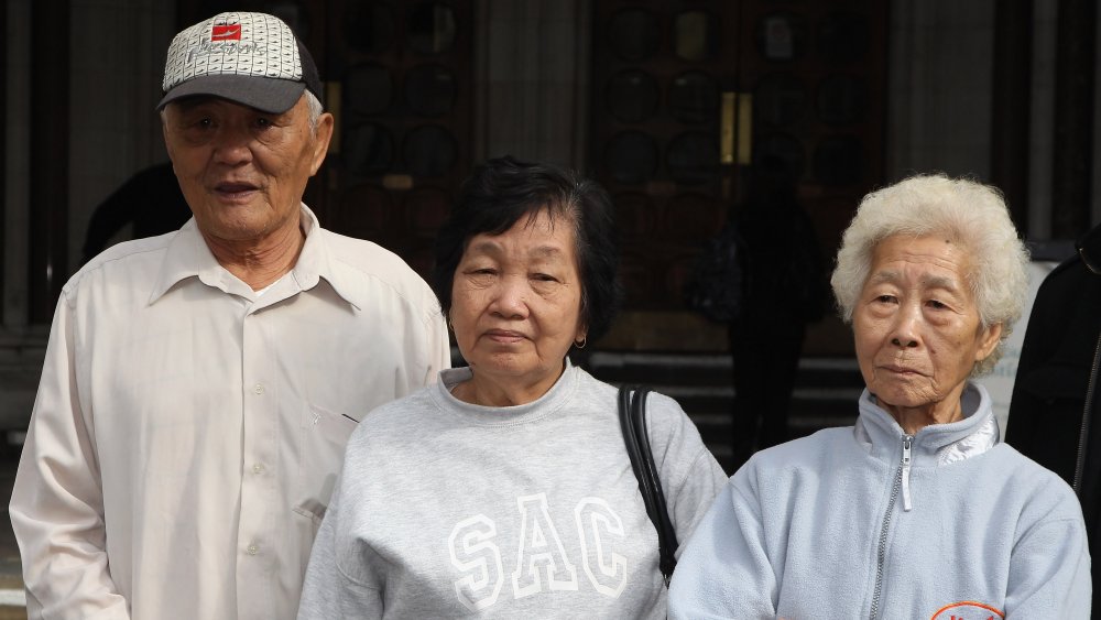 Loh Ah Choi (L) arrives at the High Court with Chang Koon Ying (C) and Lim Ah Yin (R) on May 8, 2012 in London, England for their High Court, bid to force a public inquiry into the killings of unarmed Malaysian rubber plantation workers killed in Batang Kali in 1948,