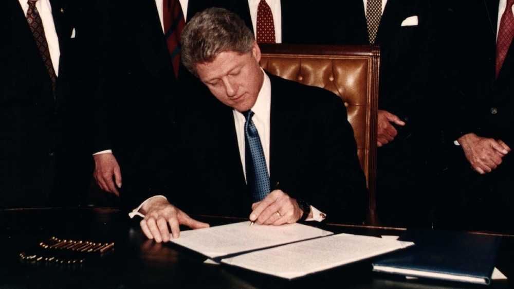 Bill Clinton signing papers