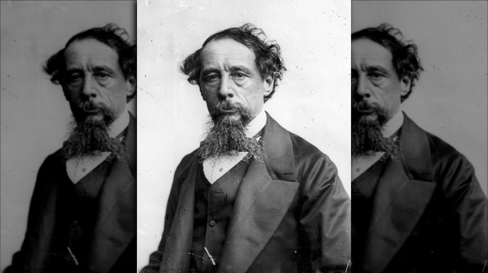 Charles Dickens posing for a portrait