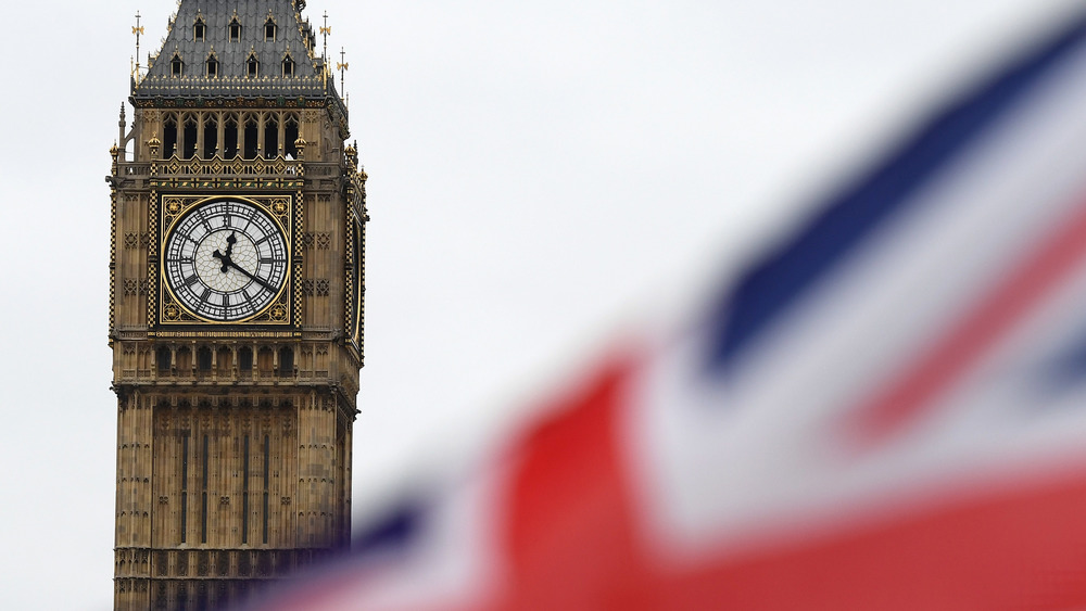 Big Ben and British flag flying in front 