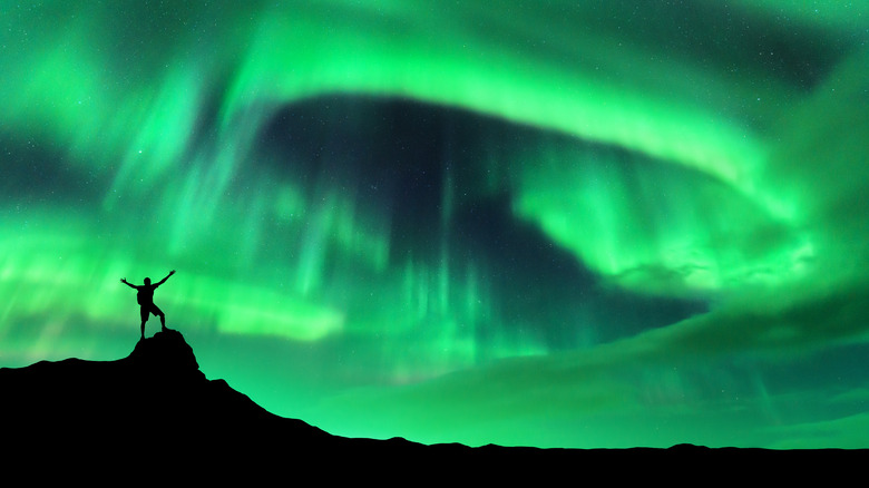 Man silhouette aurora borealis