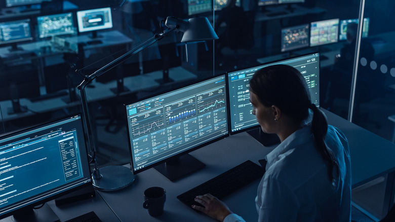 Person looking at various computer monitors