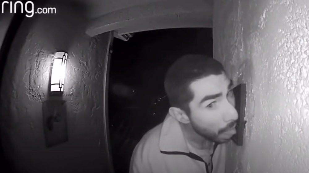 Man licking doorbell