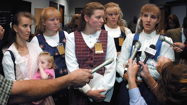 women in dressed being interviewed