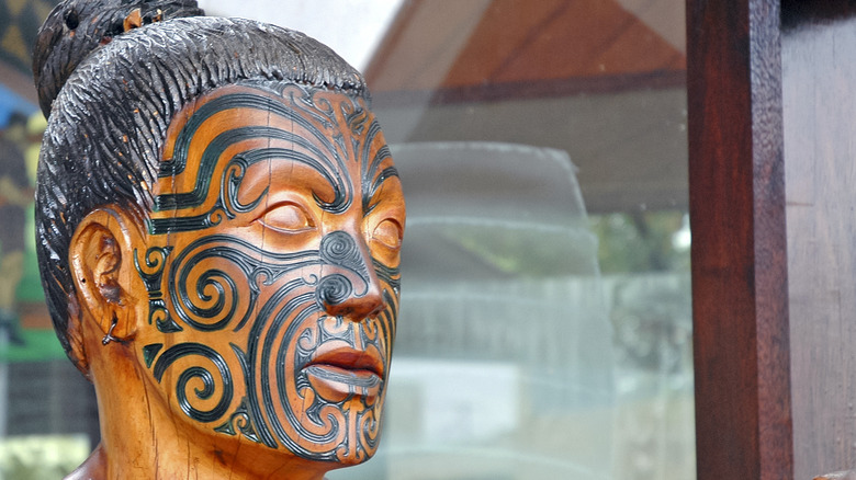 Wooden statue of tā moko tattooing
