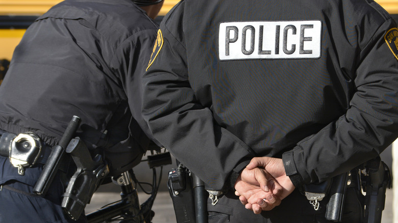 backs of two police officers