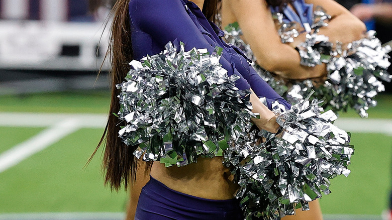 NFL cheerleaders pom-poms around waist