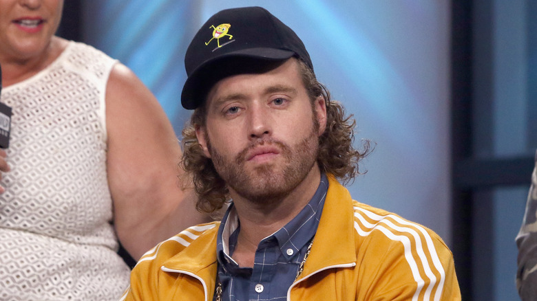 T.J. Miller cap yellow adidas jacket neutral