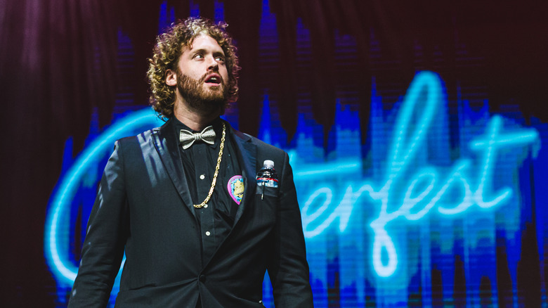 T.J. Miller black suit speaking on stage