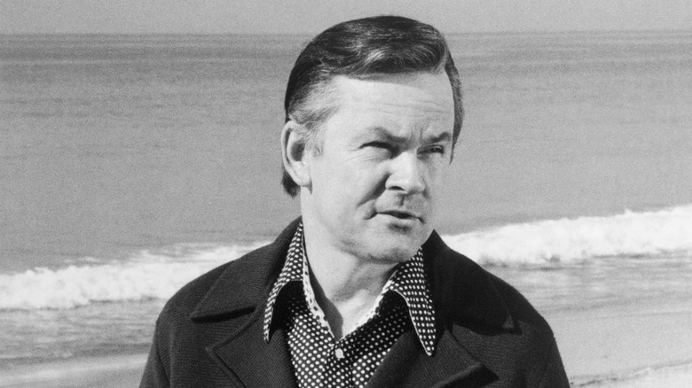 Bob Crane in coat on the beach