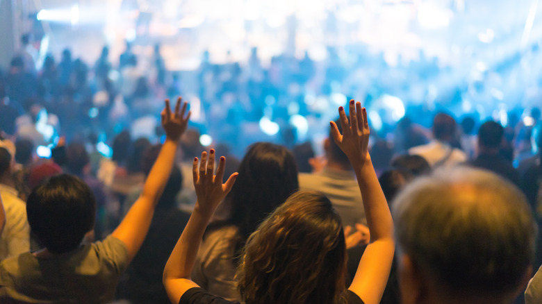 Crowd of people engaged in worship