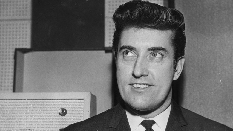 Joe Meek smiling and looking up