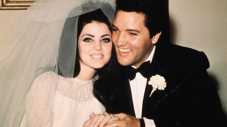 Priscilla and Elvis Presley pose for their wedding photo