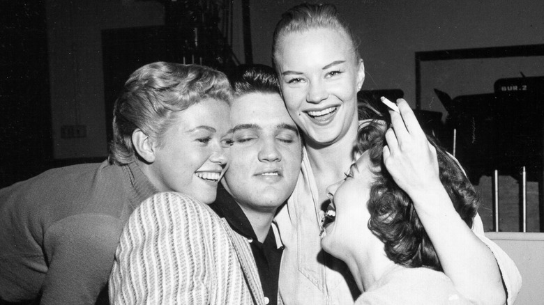 Elvis Presley is surrounded by female fans