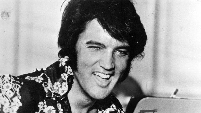 Elvis Presley smiling in floral shirt
