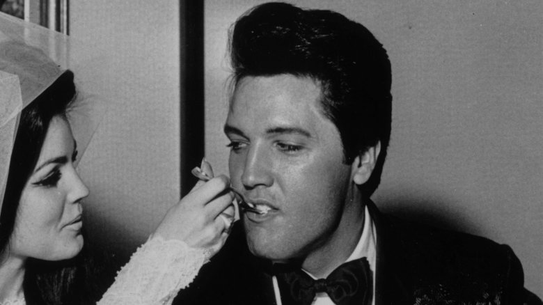 Priscilla Presley feeds Elvis Presley