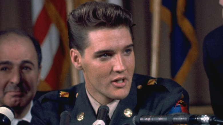 Elvis Presley delivers a press conference in uniform