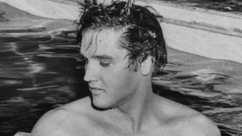 Elvis Presley swimming in a pool