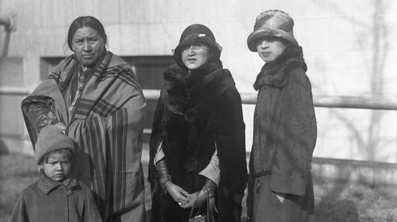 Osage people standing tradition and modern dress