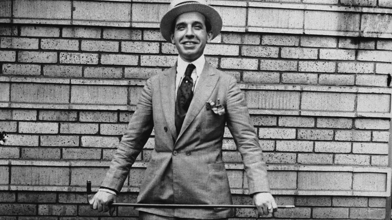 charles ponzi smiling suit holding cane