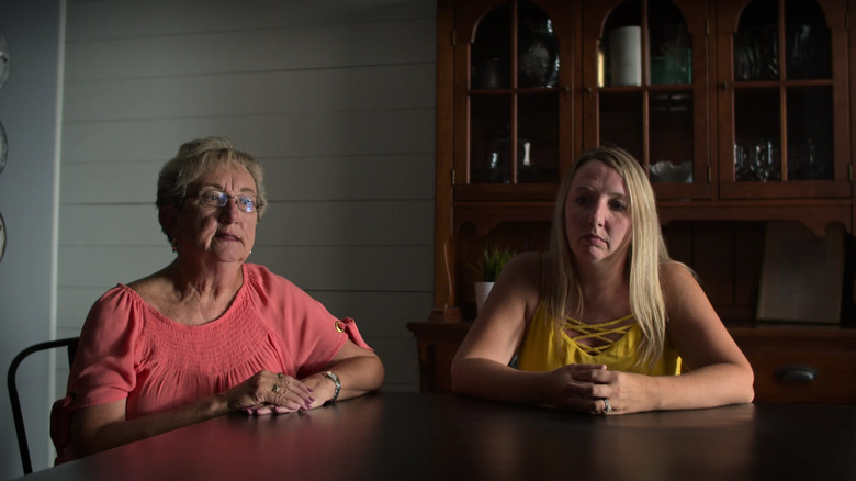 A mother and daughter sit at a table