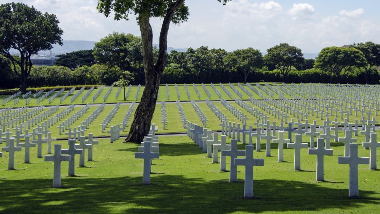 wwii graveyard with white cross tombstones