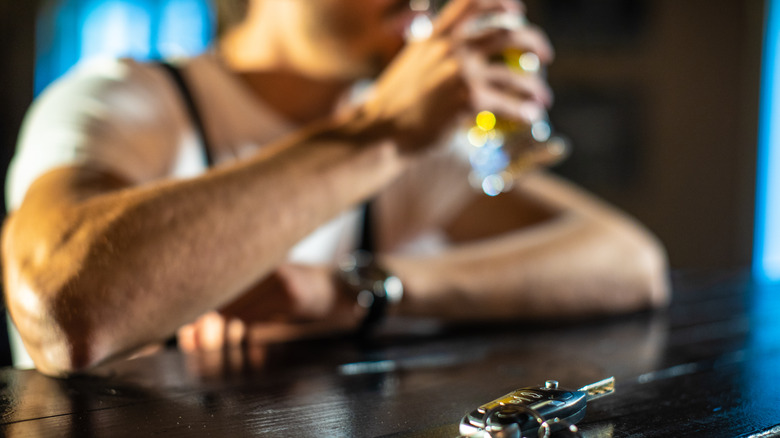 man at bar keys in foreground