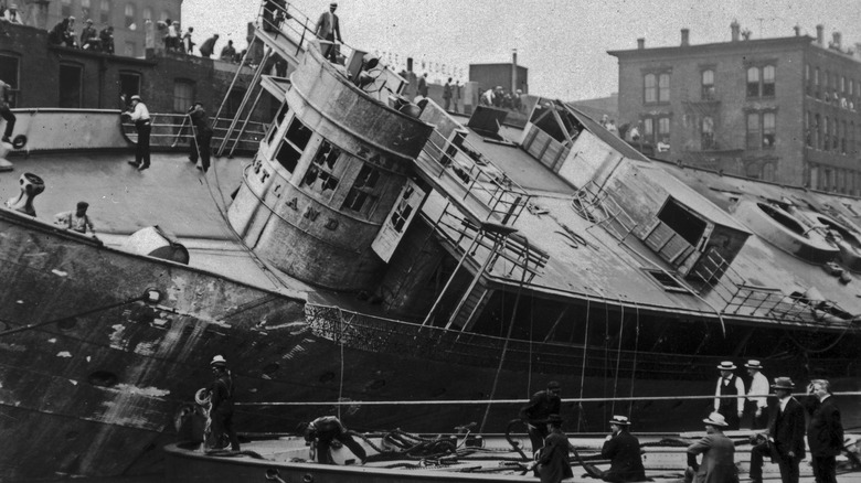 SS Eastland leaning in harbor men ropes