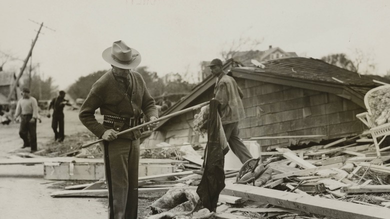 the storm damage from the Hurricane of 1938, Keene New Hampshire showing men pulling on something