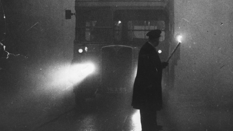 Man directs bus in smog
