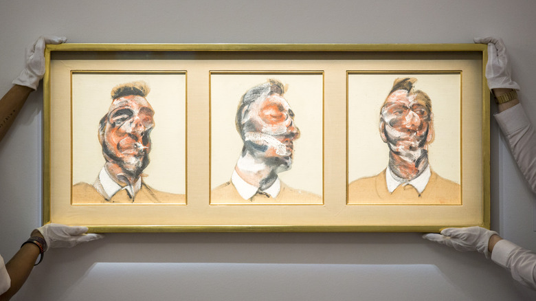 Assistants hold Francis Bacon's three studies