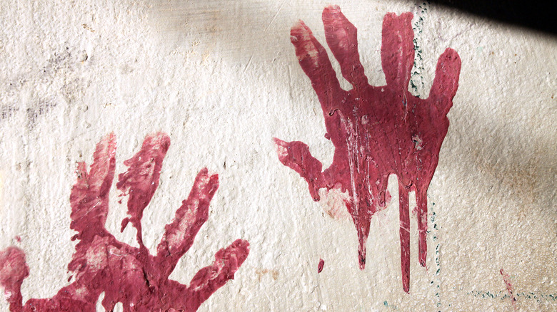 bloody handprints on wall