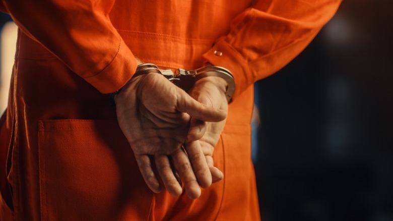 man in jumpsuit in handcuffs