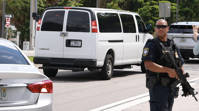 Police guards passing van