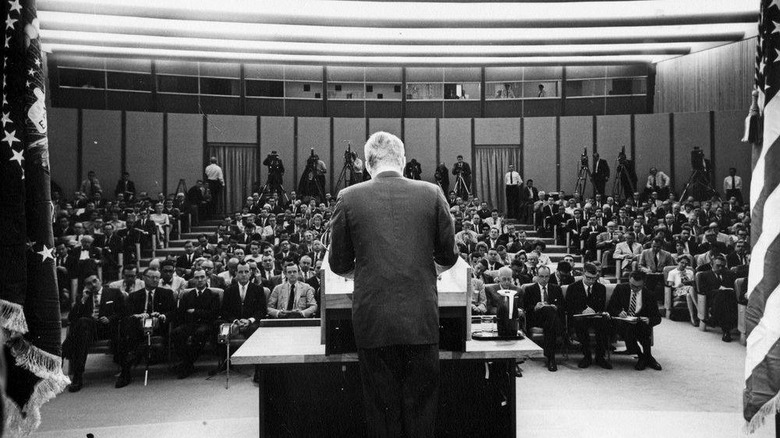 JFK facing press