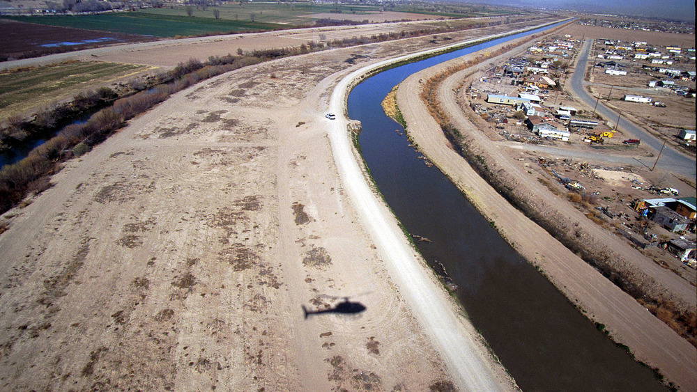 A U.S. Customs Chopper Casts A Shadow As Pilot Randy Donnelson Flies Over The Rio Grande In El Paso, Texas On February 24, 1999.