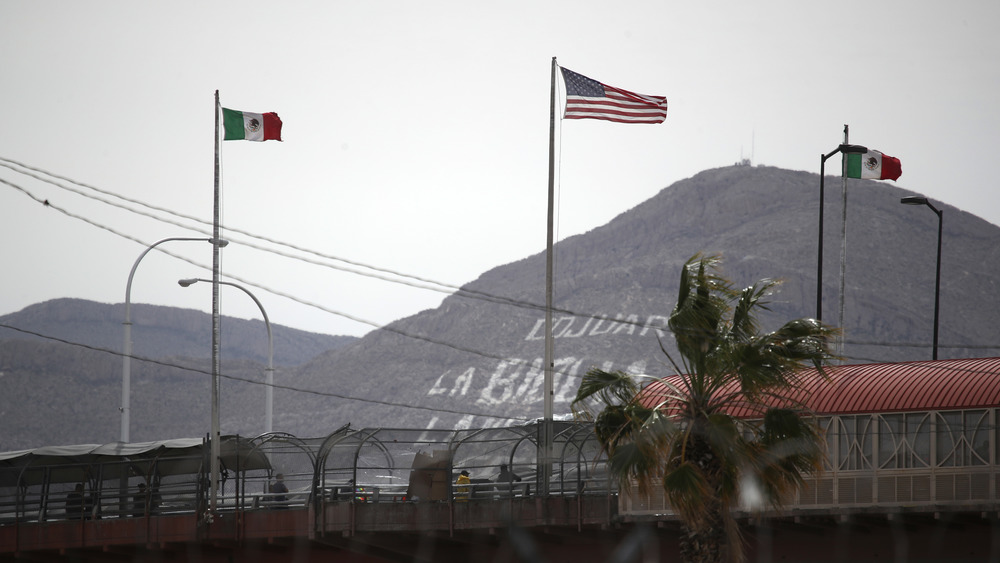 American and Mexican flag fly over the Paso del Norte International Bridge on March 30, 2019 in El Paso, Texas. 