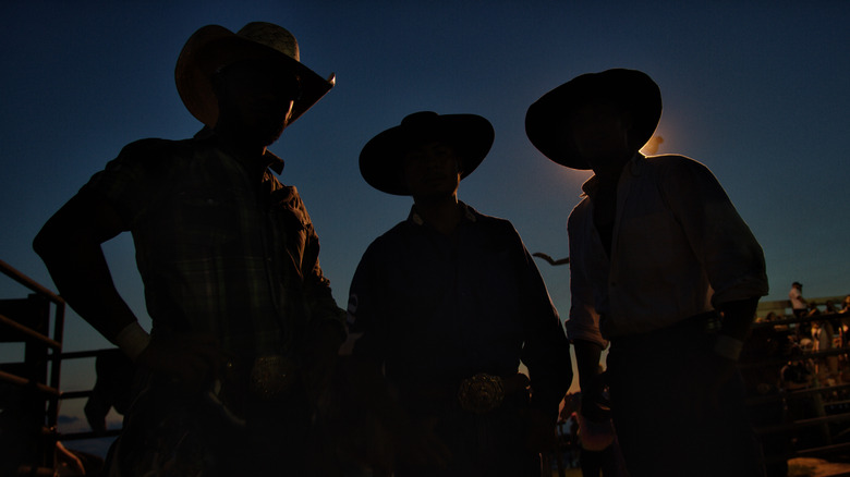 Three shadowy deputies in cowboy hats