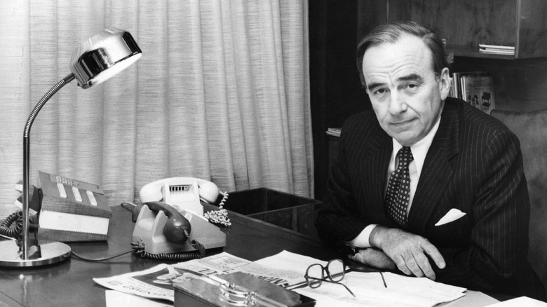 Rupert Murdoch poses at his desk