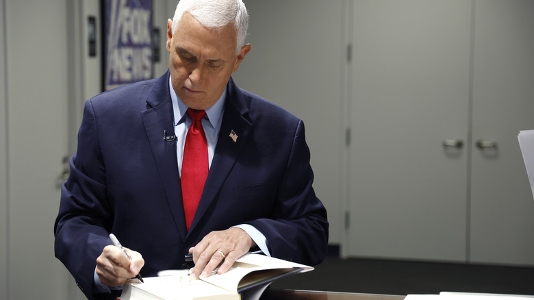 Mike Pence signs a copy of his book