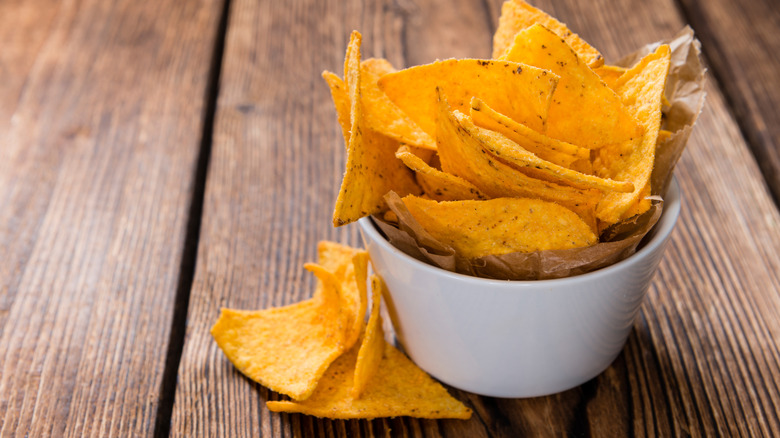 Person picking up Doritos chip