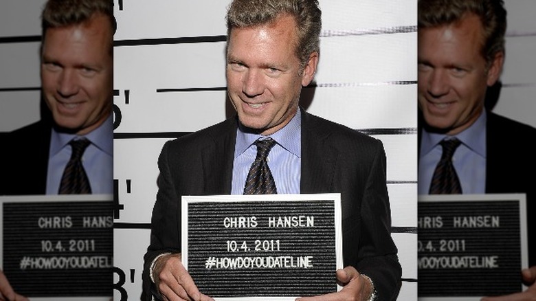 chris hansen posing with name plate