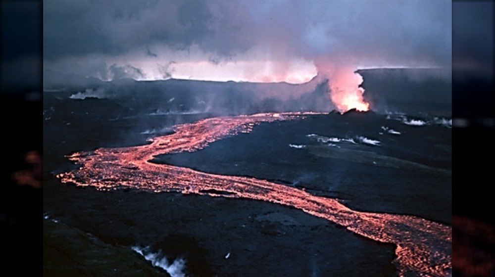 Lava flowing over black ground